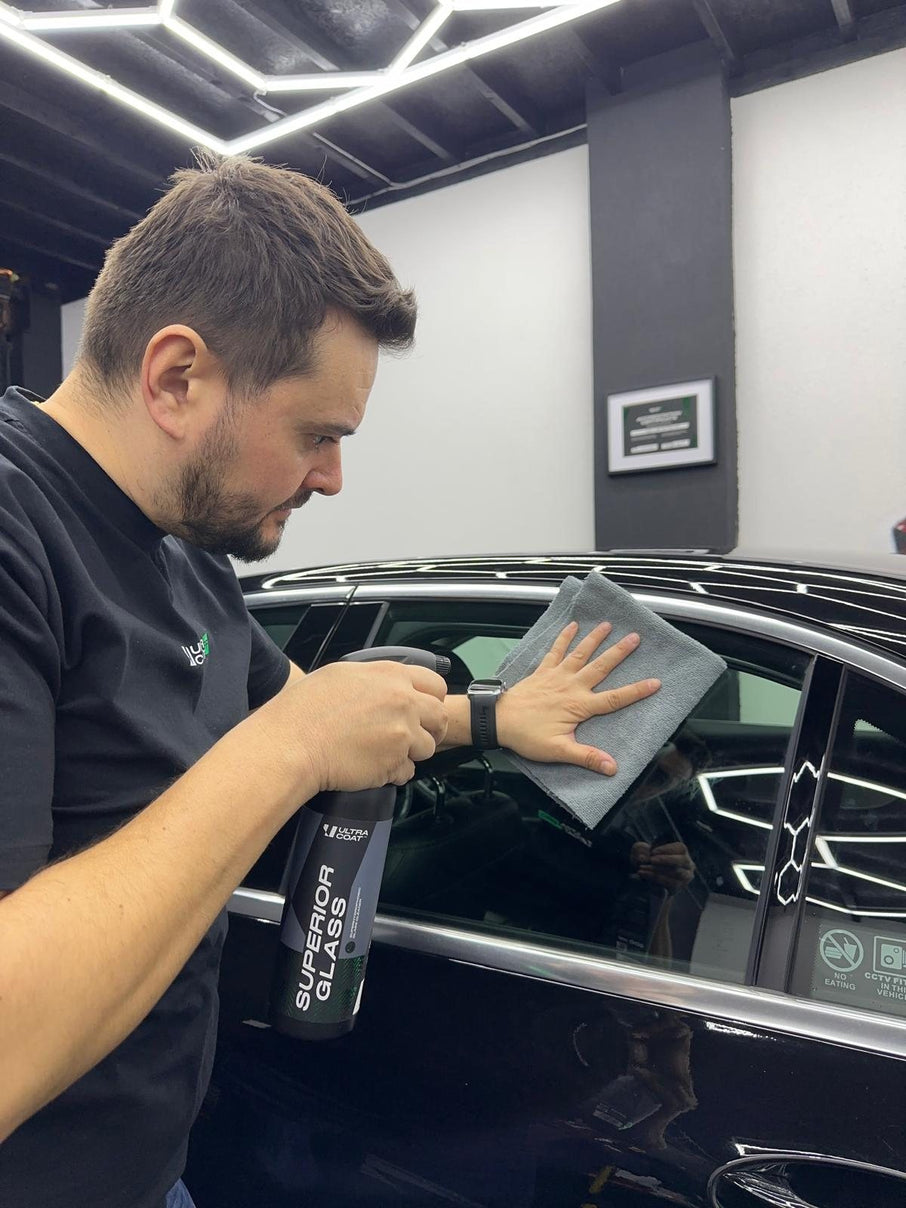 George from GS Car Detailing applying ULTRACOAT Superior Glass to a car window in his Liverpool studio.