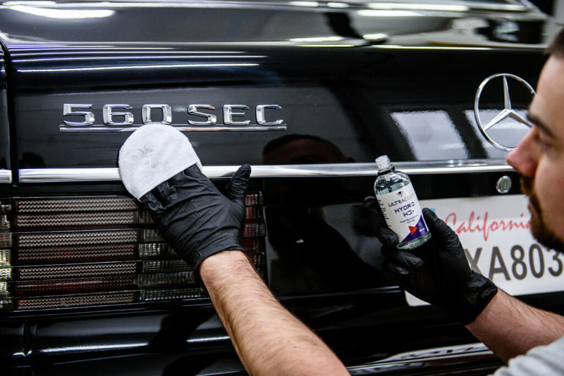 DIY exterior car detailing on a driveway