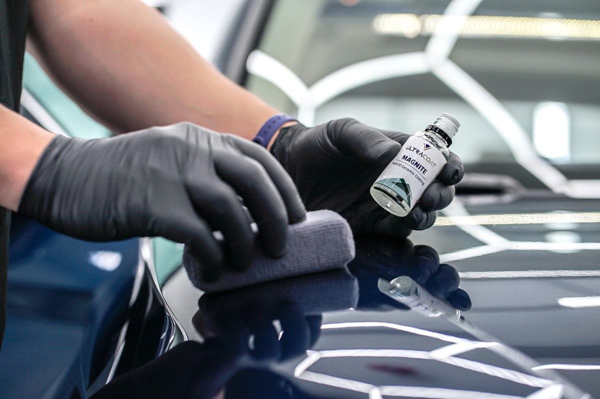 Applying Ultracoat Magnite with a suede applicator block on gloss black paint