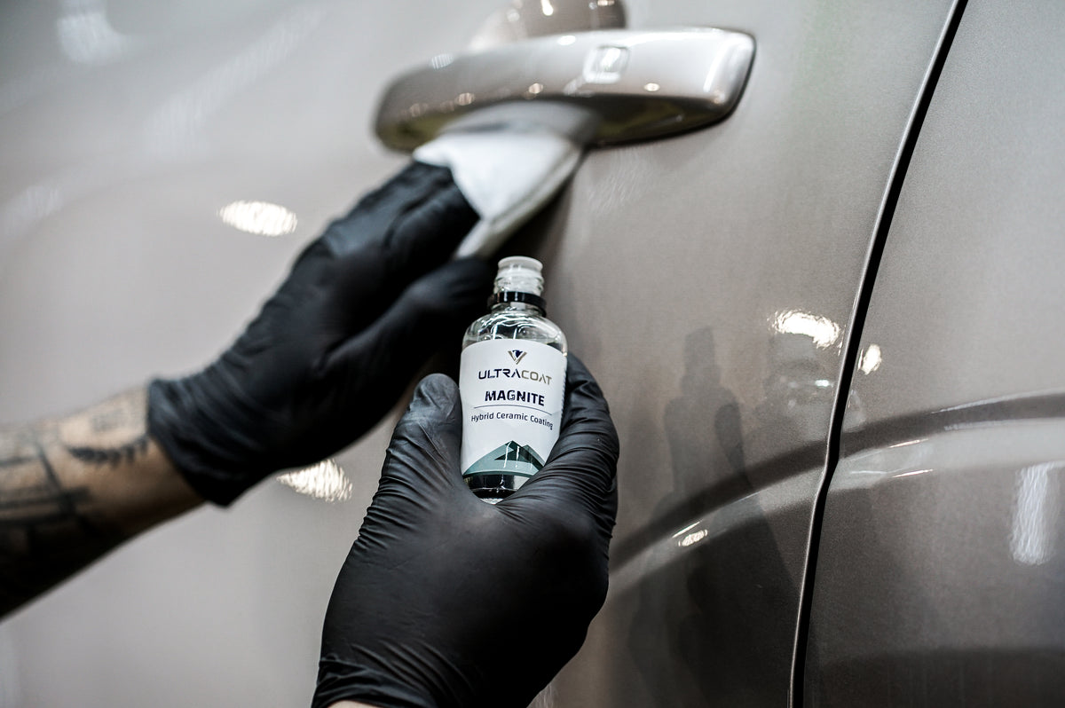 Detailer applying Ultracoat Magnite hybrid ceramic coating around a car door handle
